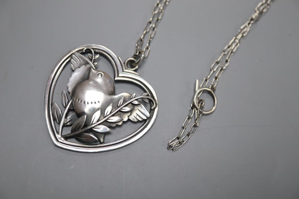 A George Jensen sterling Robin & fearn heart shaped pendant, with white metal necklace, no. 97, 41mm, gross 15.6 grams.